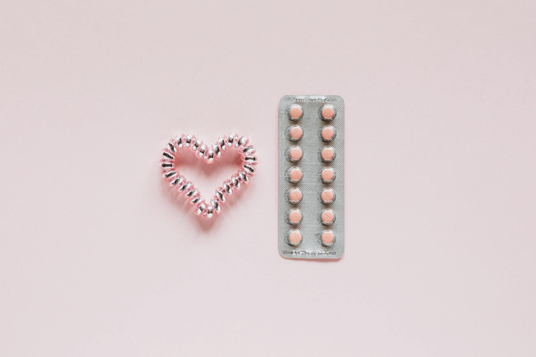 glistening heart near packaging with pills