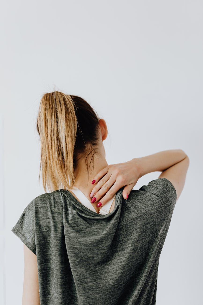back view of a woman having a neck pain