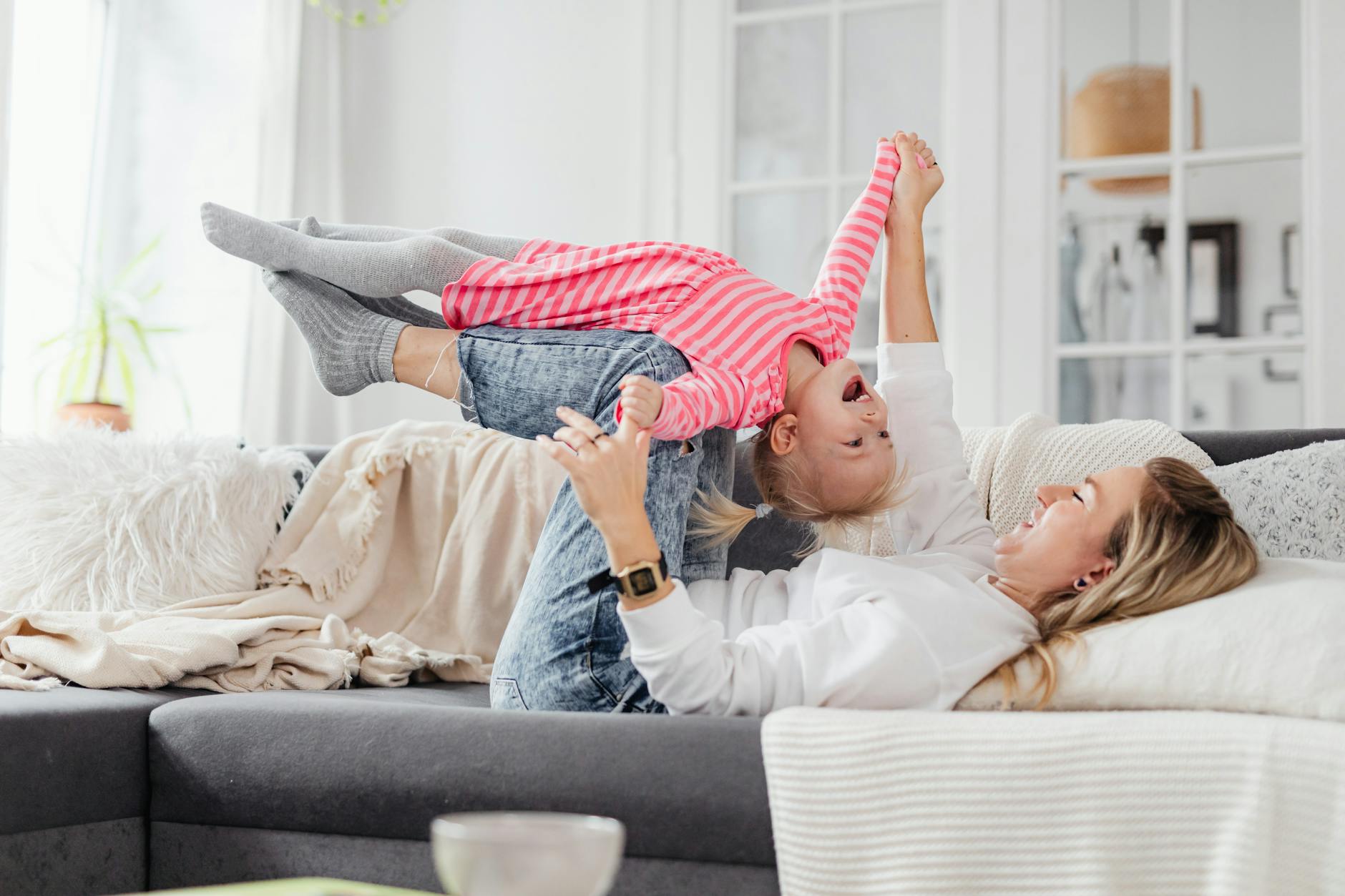 blonde girl lying on the woman s shin