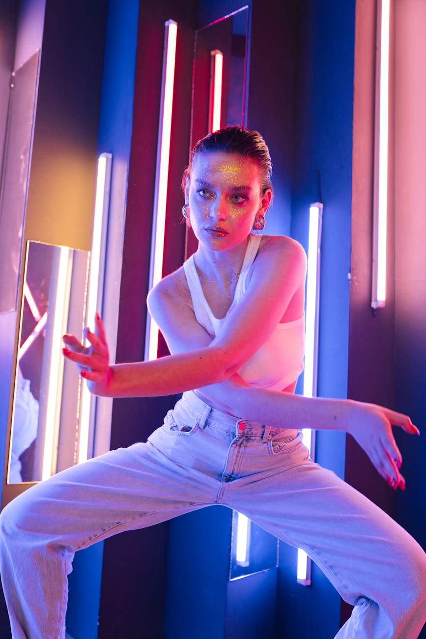 a woman in white top and denim jeans dancing
